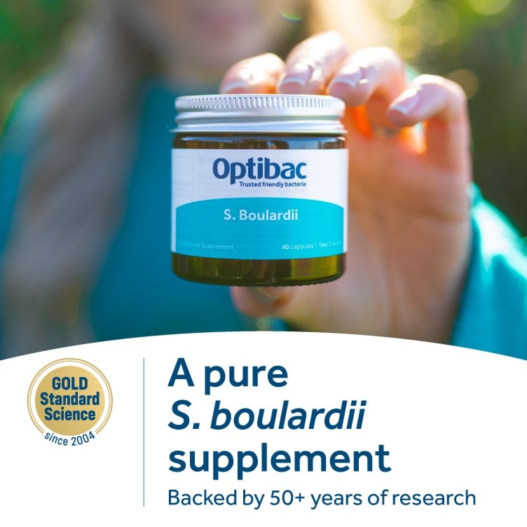 Optibac Boulardii supplement jar held outdoors – pure Saccharomyces boulardii live cultures.