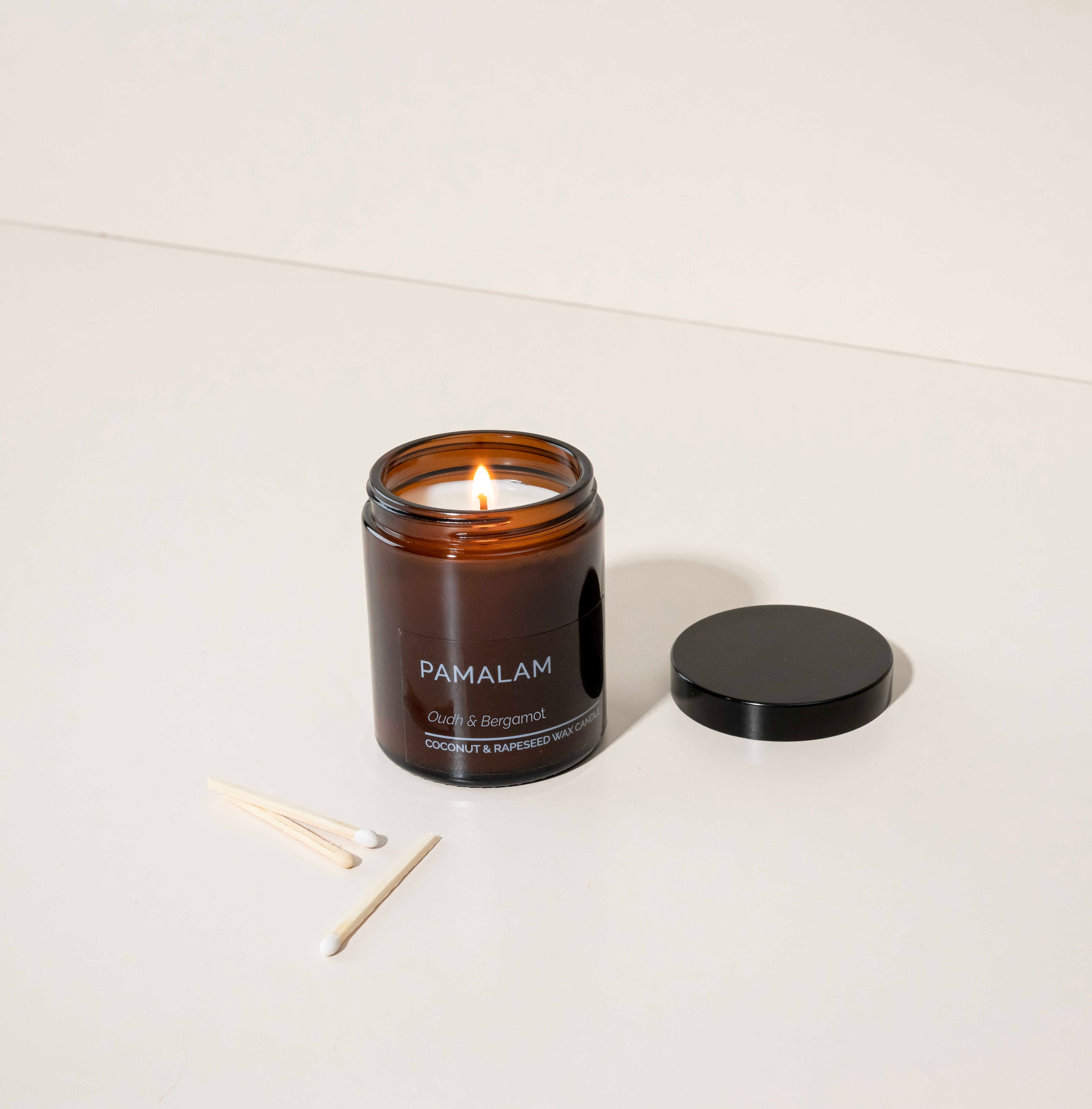 Pamalam Oudh & Bergamot 180g candle in amber glass jar