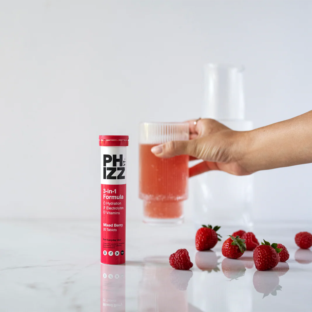 Phizz Mixed Berry electrolyte hydration drink poured into glass — effervescent vitamin tablets
