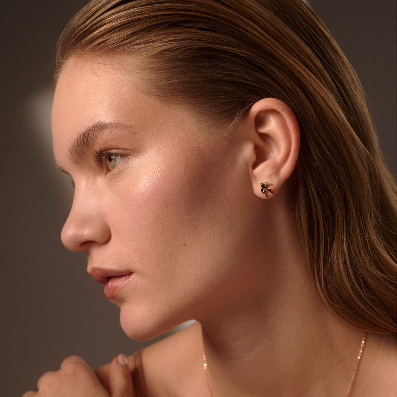 Gold swallow stud earrings by Tipperary Crystal, dainty bird design in elegant gift box, perfect women’s jewellery gift