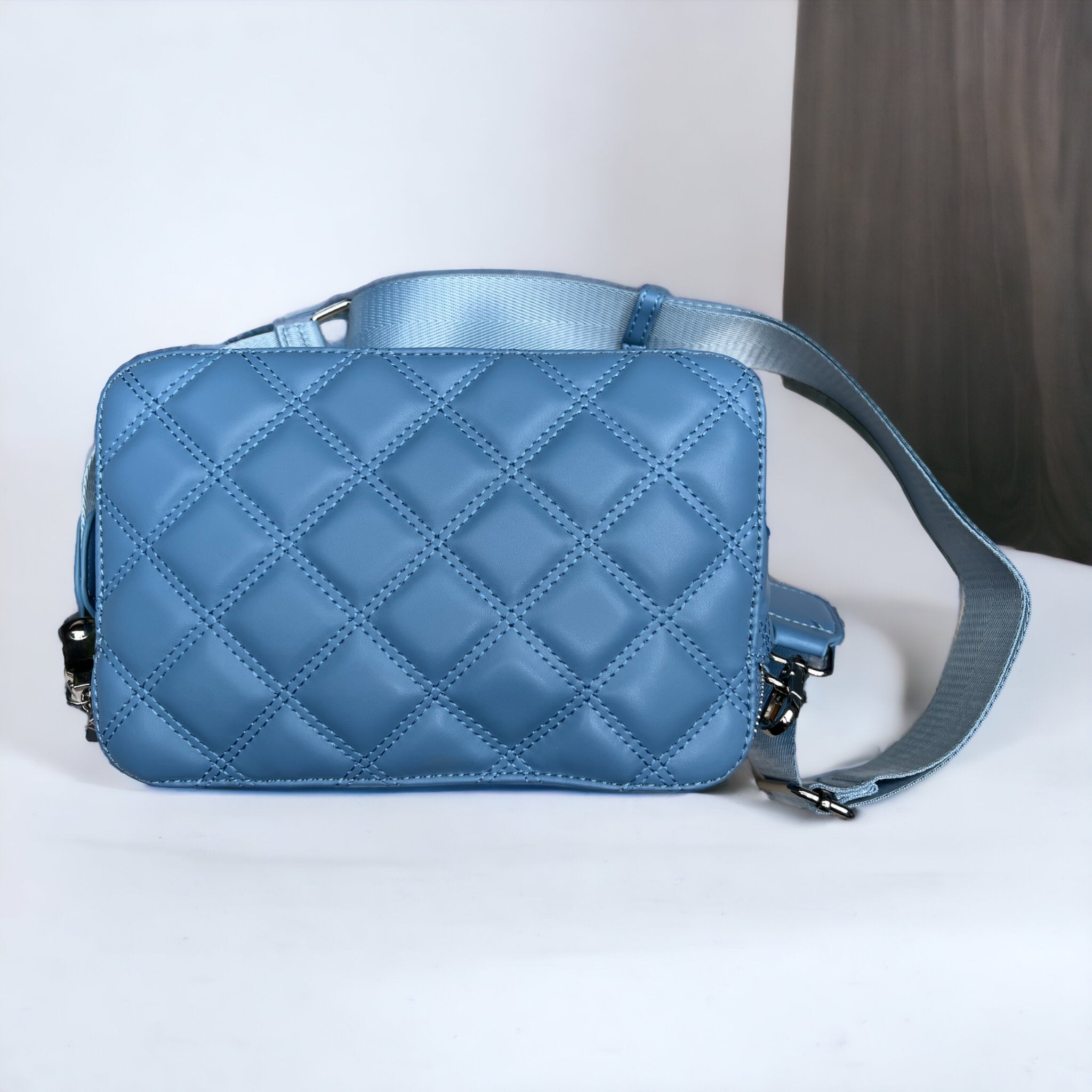 Jenny Glow Blue Quilted Logo Crossbody Handbag From Back