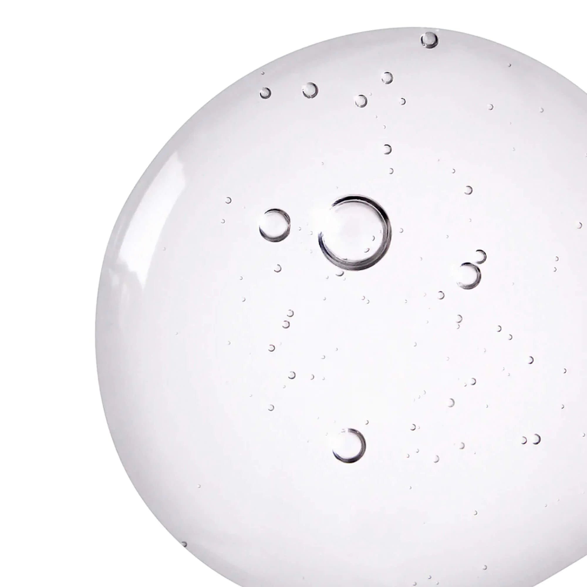 Drop of BeautyPro blemish control serum close-up on clear surface
