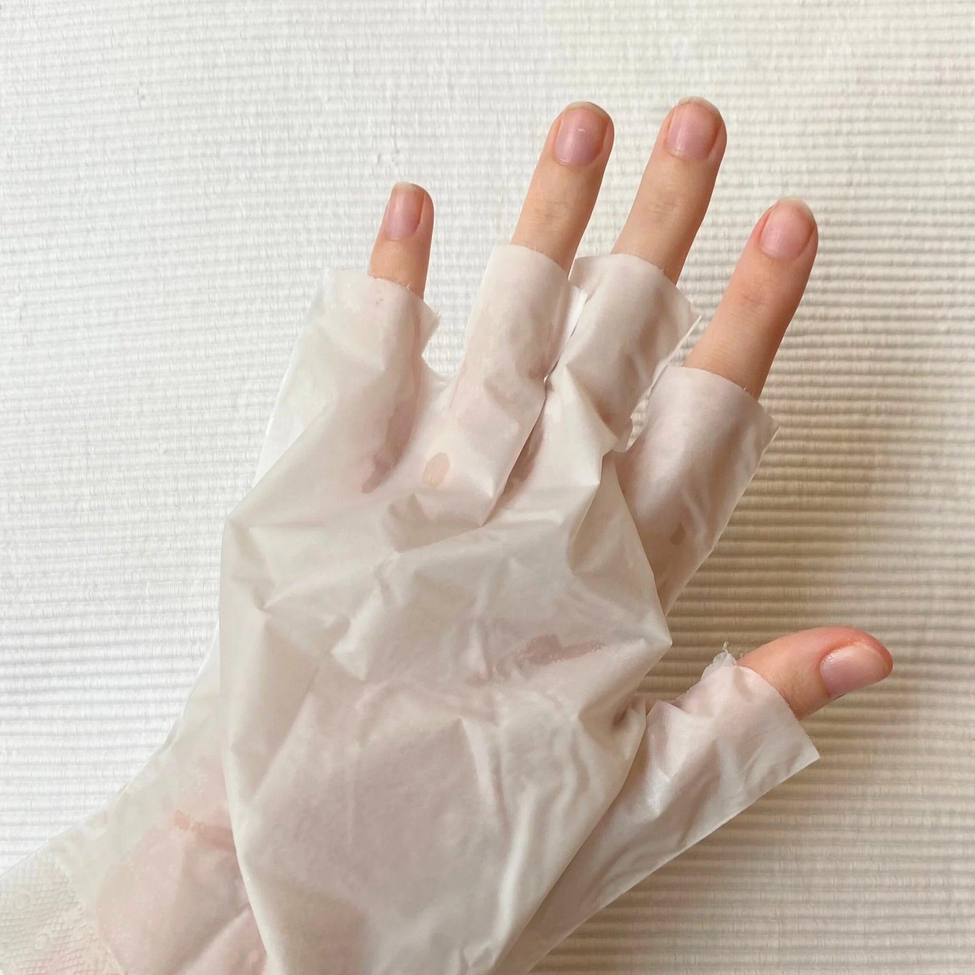 	Close-up of BeautyPro hydrating hand gloves on hands during treatment