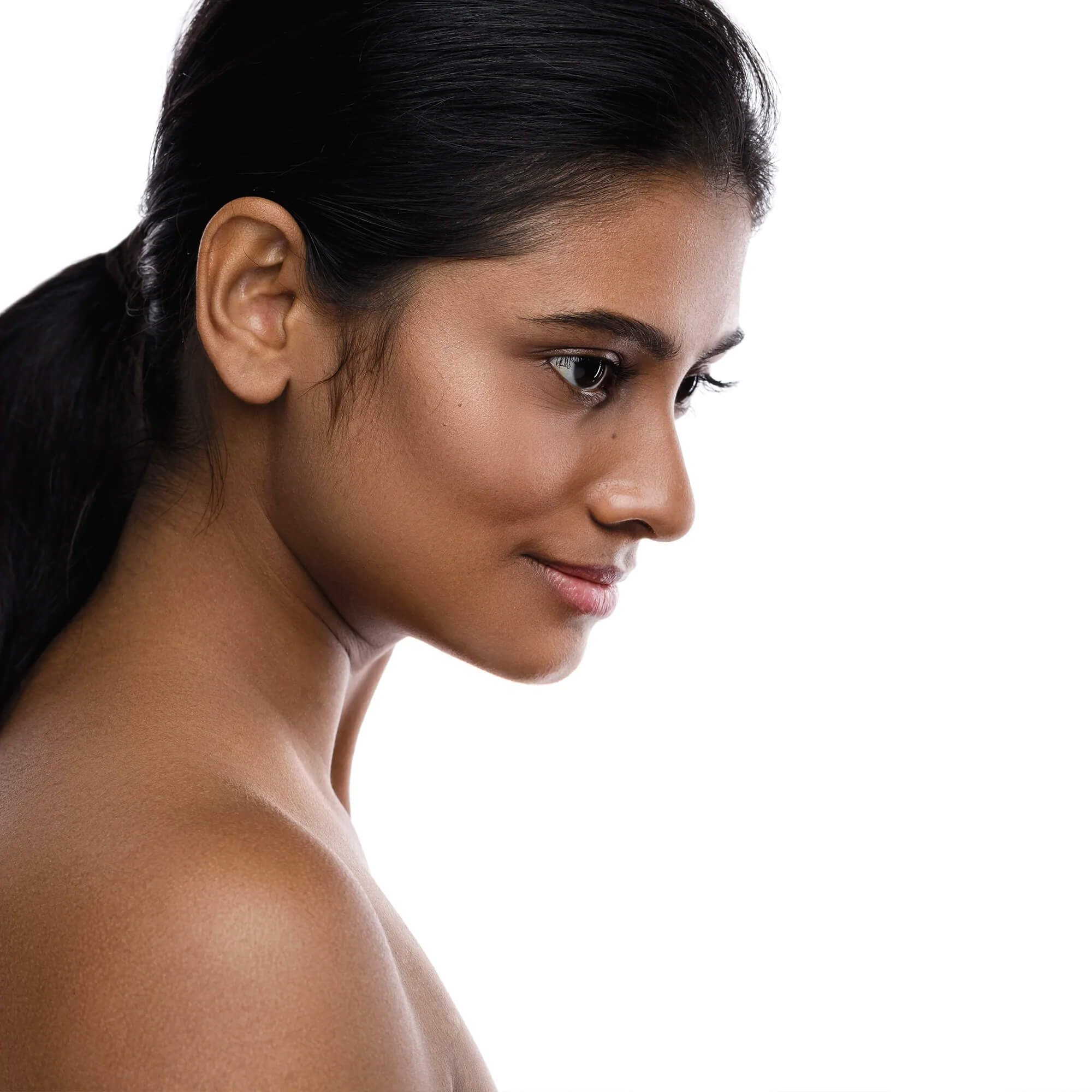 Smiling woman applying BeautyPro Hydrating Serum to her glowing skin