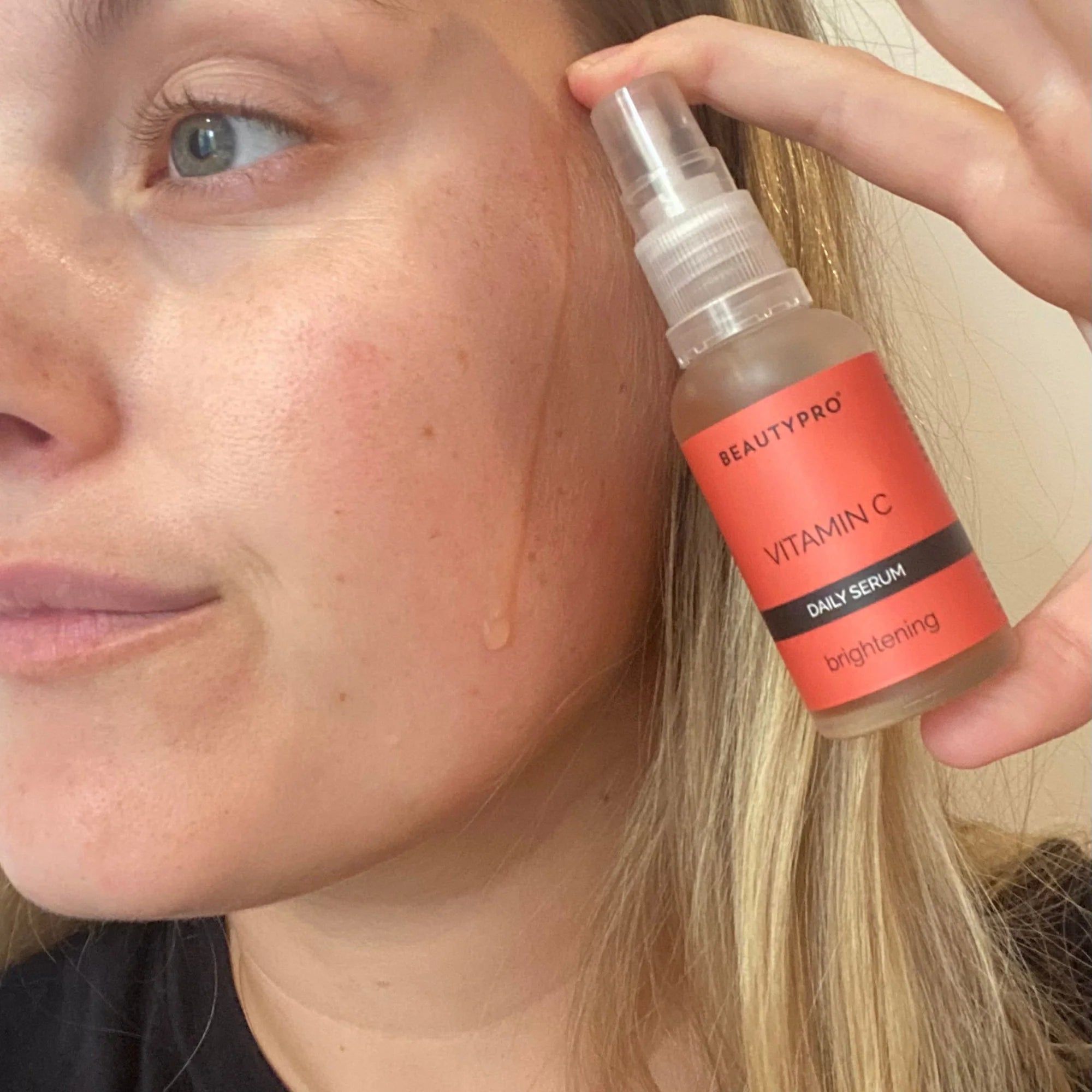 Applying BeautyPro Brightening Vitamin C Serum to clean skin