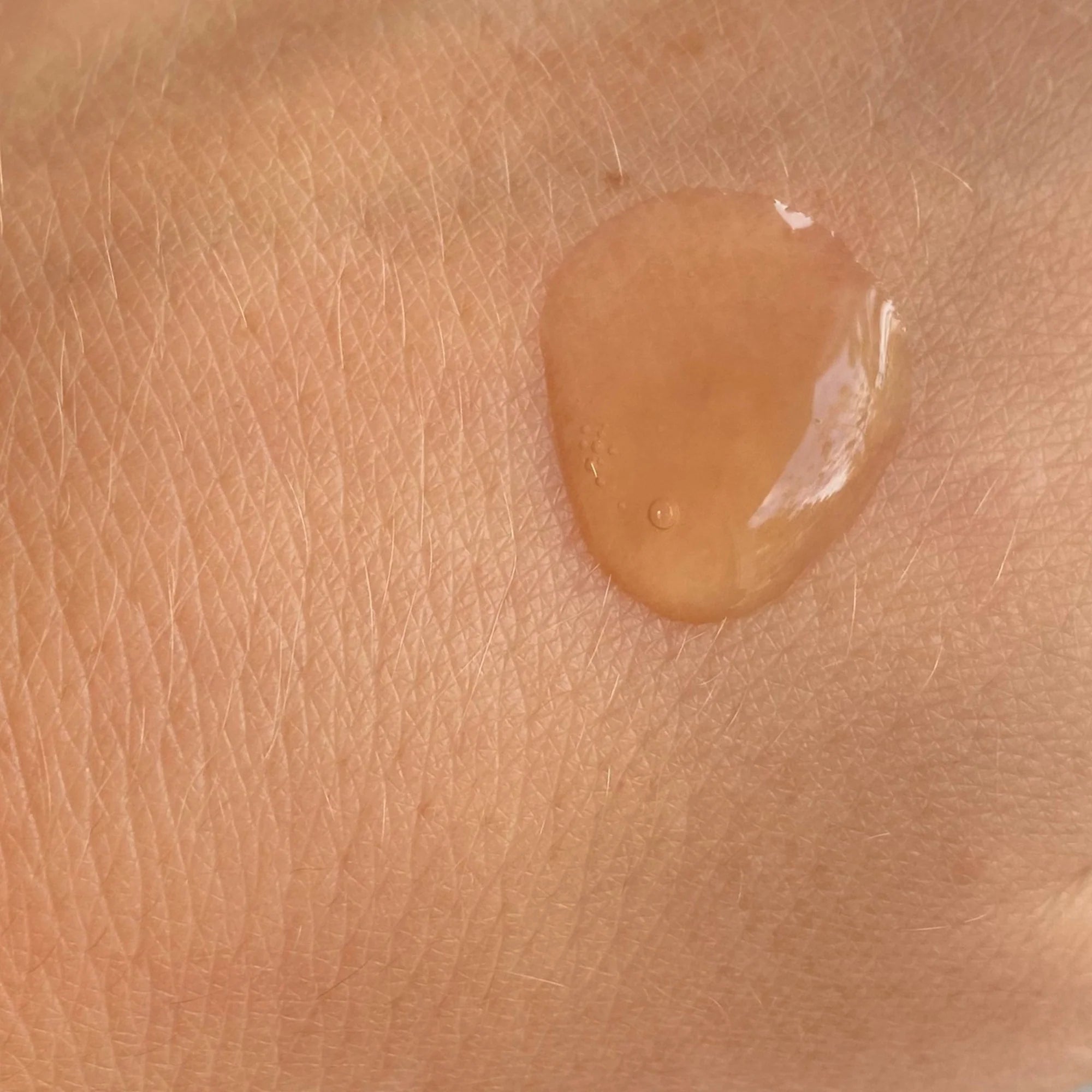 Close-up of BeautyPro Vitamin C Serum texture on skin