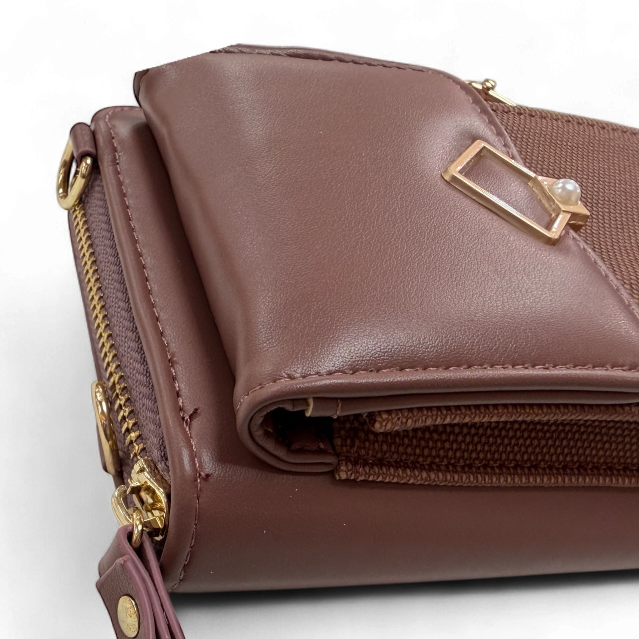Side view of dusty mauve crossbody phone purse with zip compartment