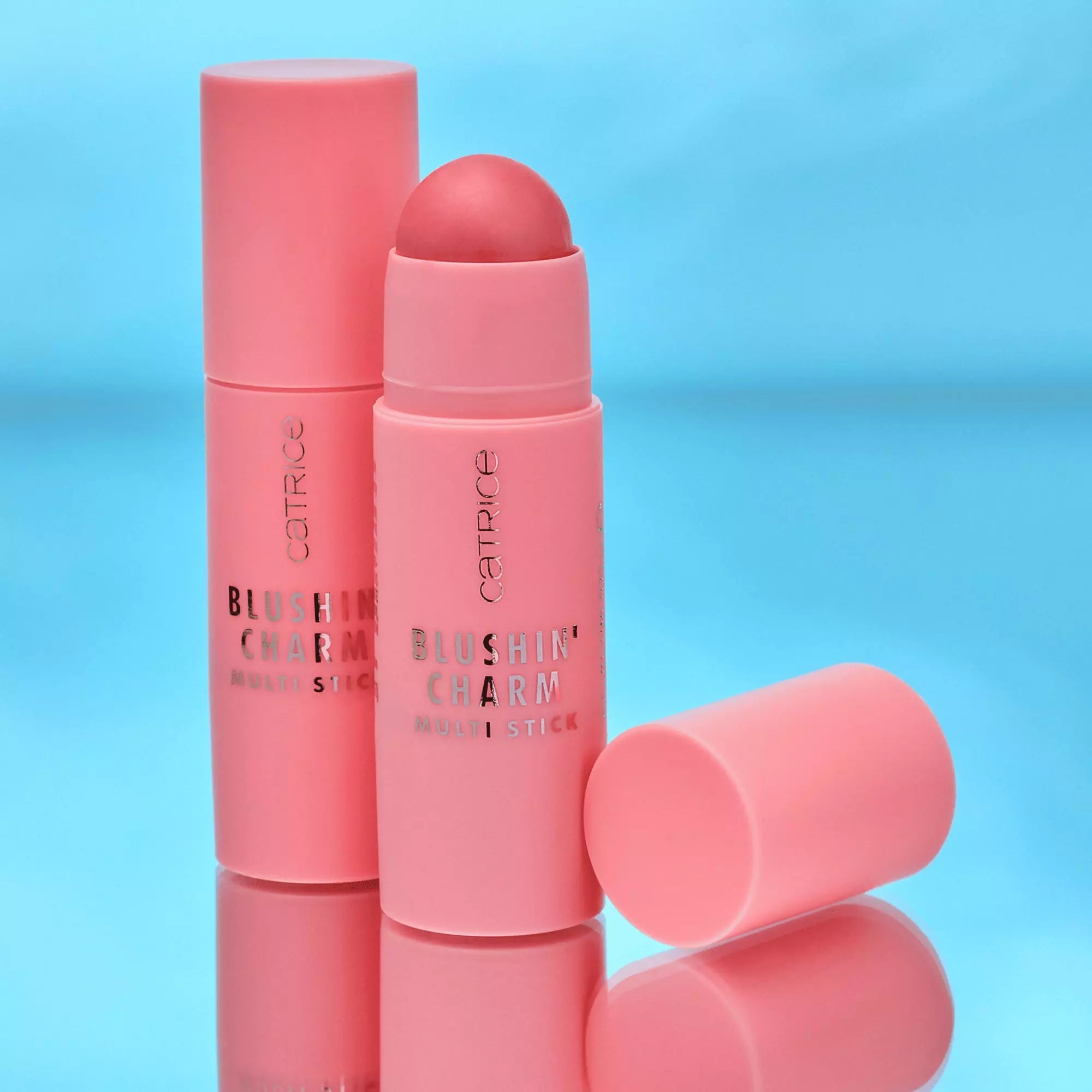 Stack of Catrice Blushin’ Charm Multi Sticks Sparkle Lover displayed against blue background