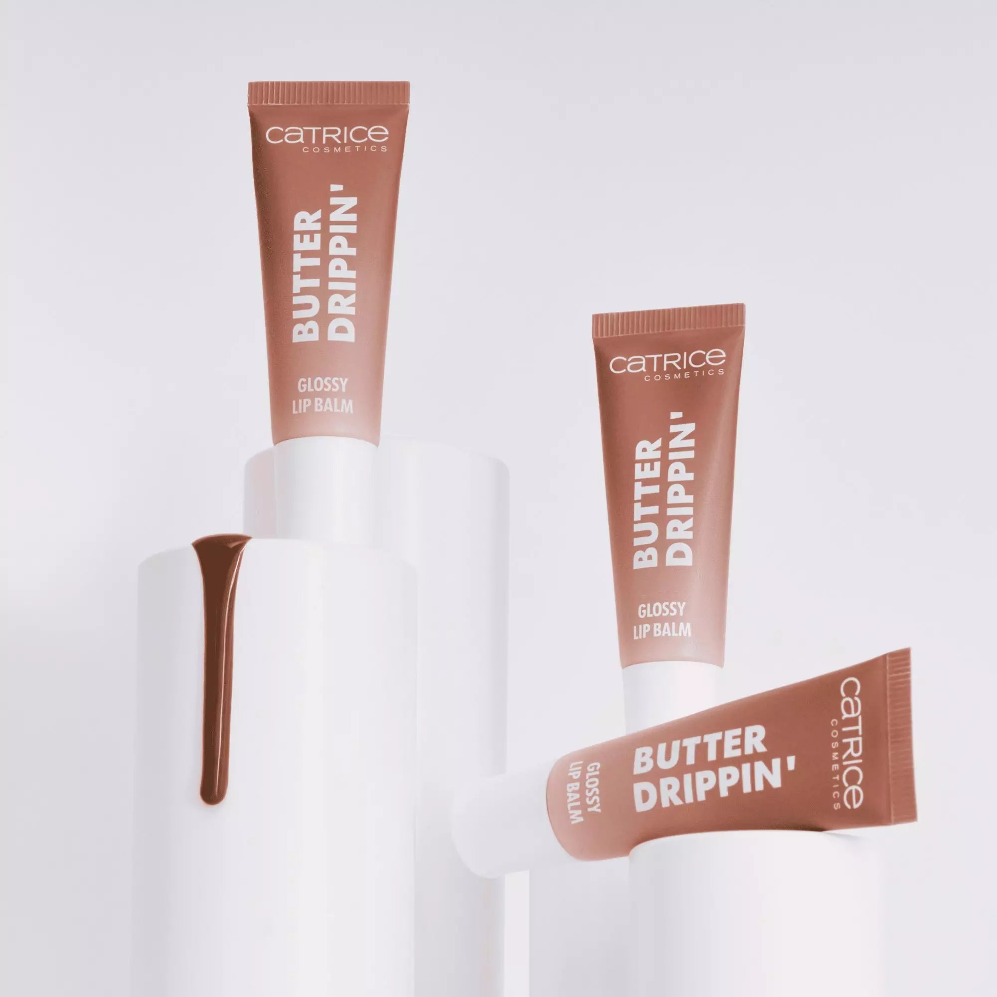 Side view of Catrice Butter Drippin’ Glossy Lip Balm 020 Maple Latte on white background 