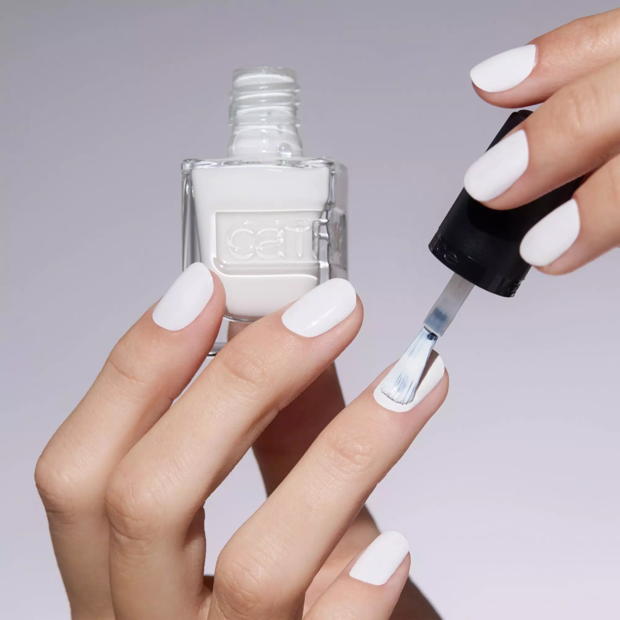 Manicured hand holding Catrice Ibiza Feeling nail polish
