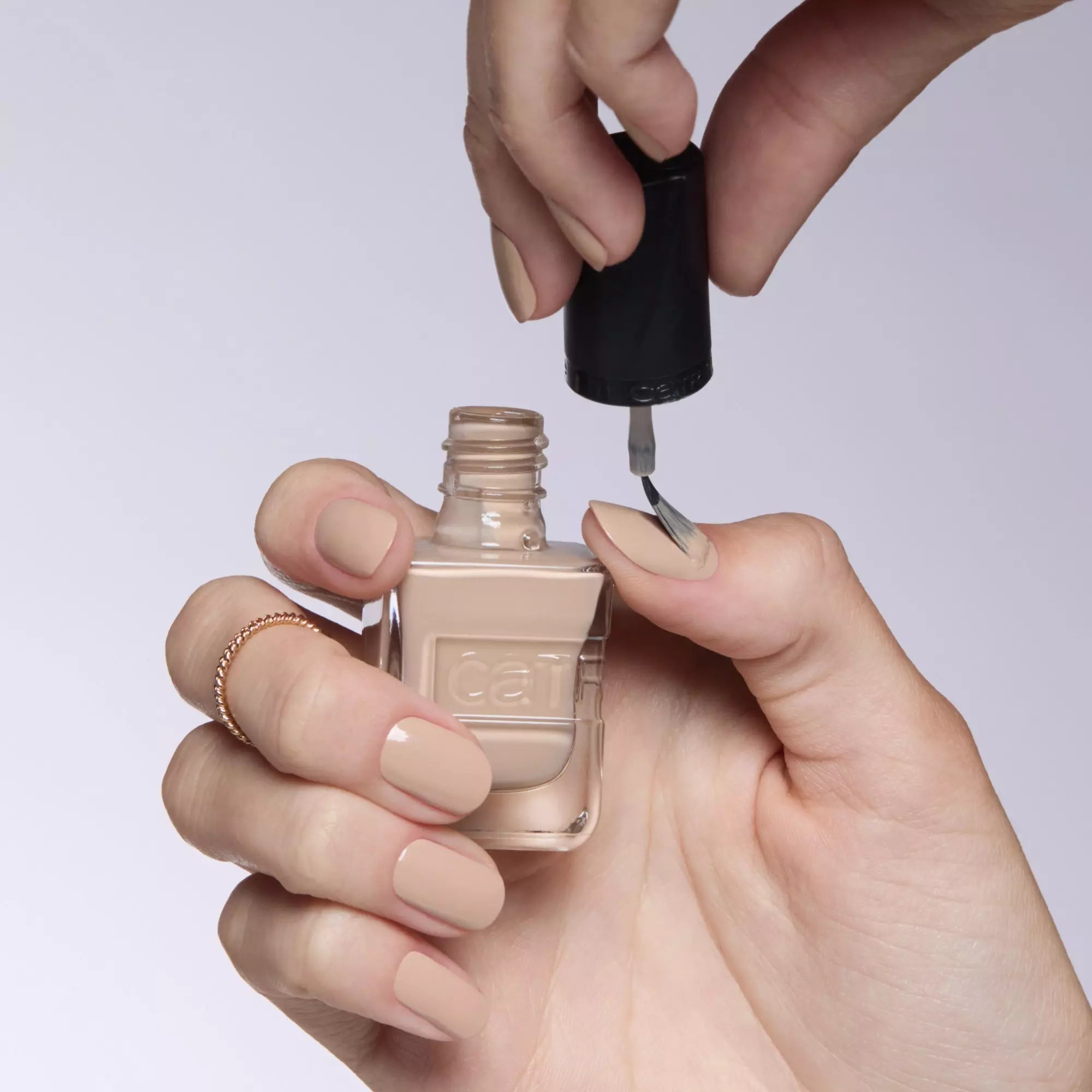 Applying nude beige gel-effect polish – Catrice 010 nail lacquer