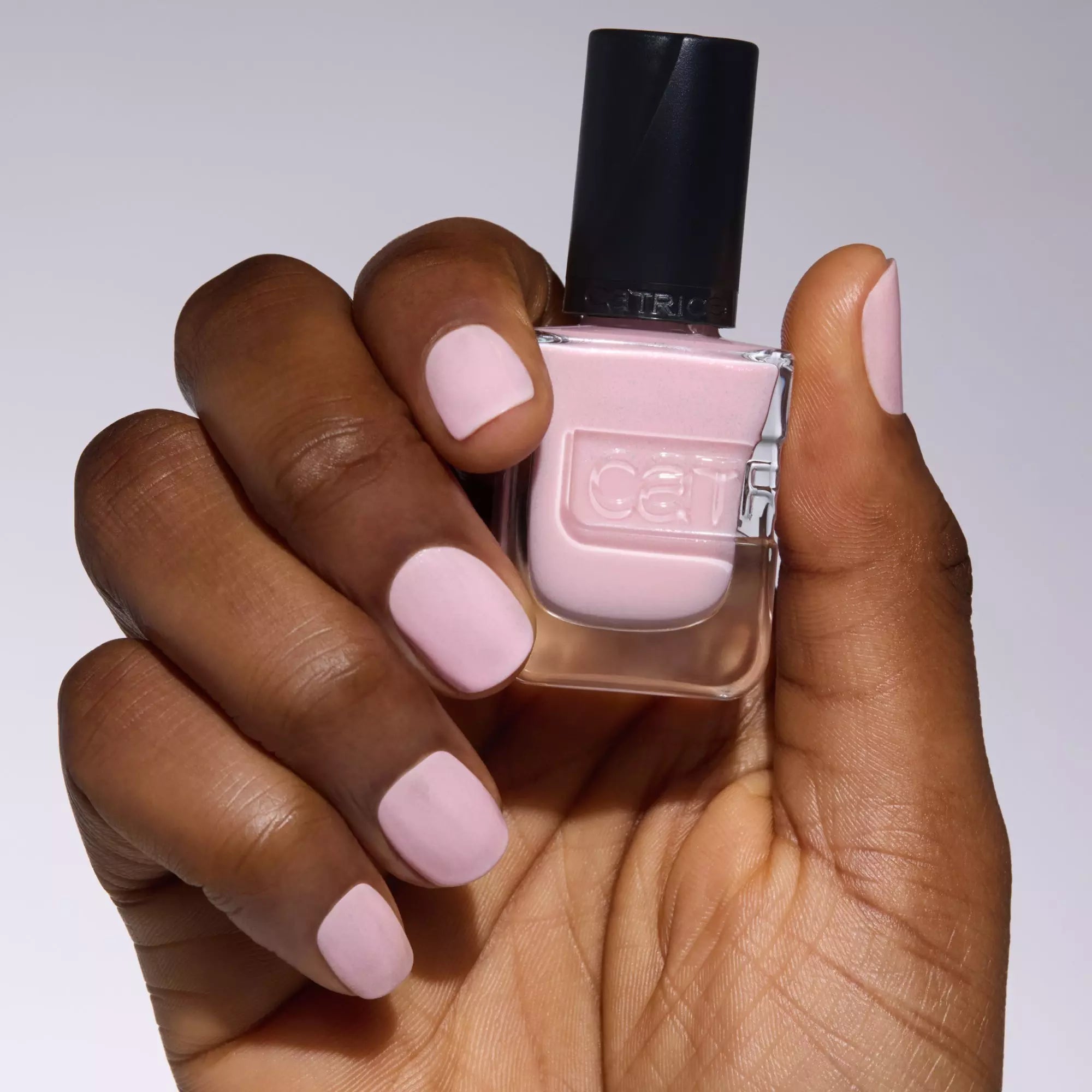 Model holding Catrice Gel Affair Nail Lacquer in pastel pink shade