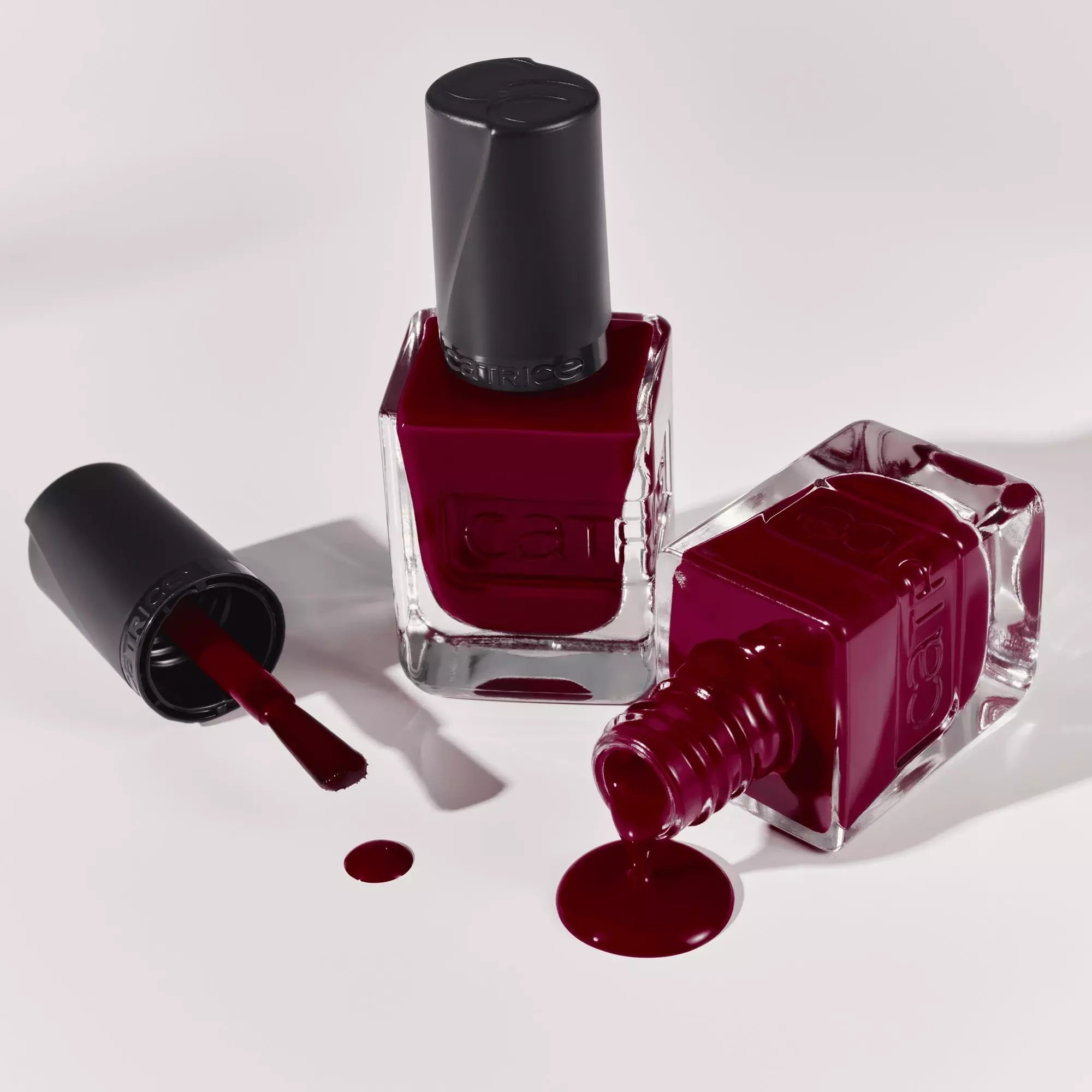 Flatlay of Catrice Gel Affair Nail Polishes including 021 Caught On The Red Carpet - Dark Red and Glossy Finish