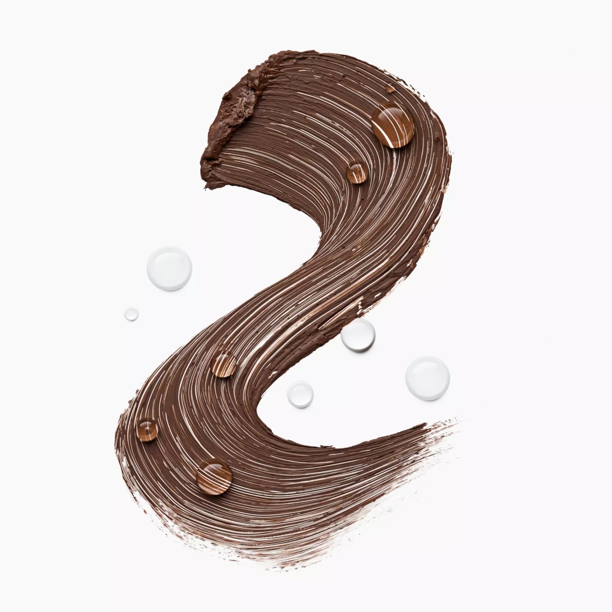 Waterproof brown mascara swatch from Catrice Glam & Doll range with water droplets