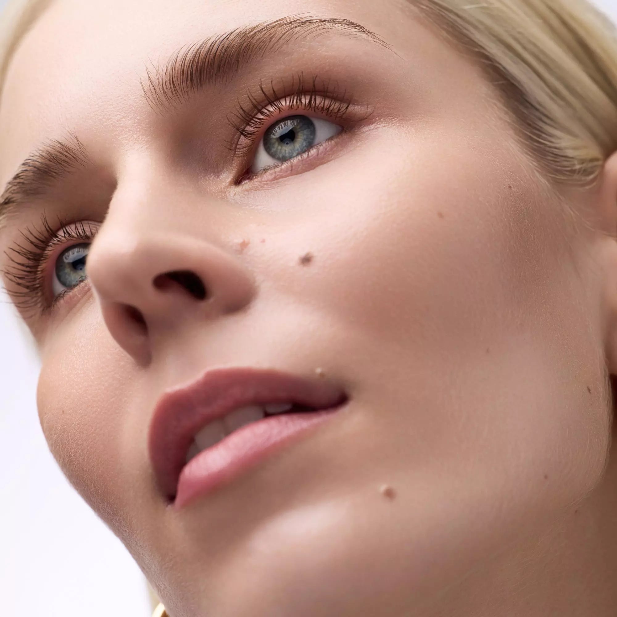 Model wearing Catrice Glam & Doll brown mascara on lashes