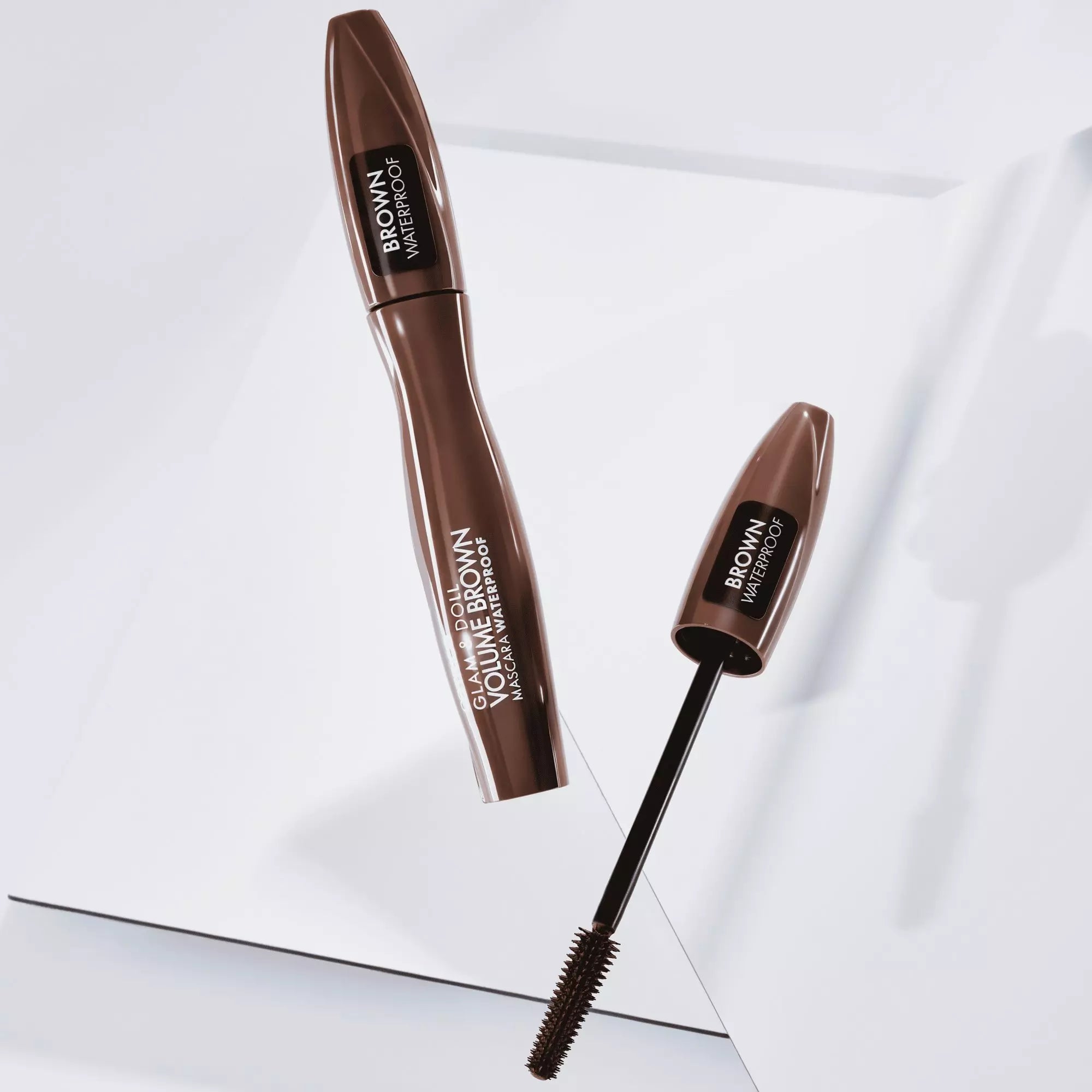 Catrice Glam & Doll Brown Mascara laying flat with open wand on white background