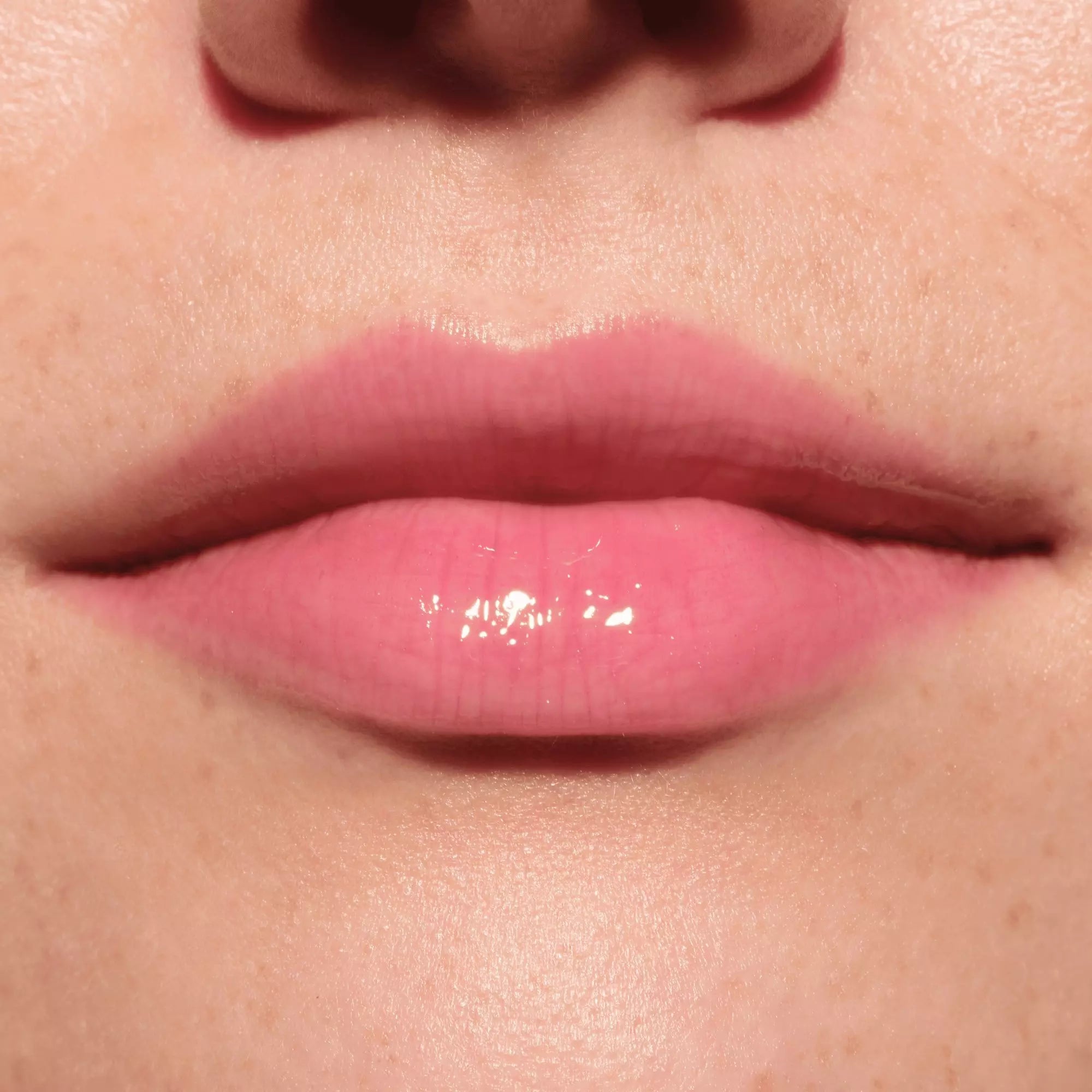 Catrice Glossin’ Glow tinted lip oil warm plum shade on lips