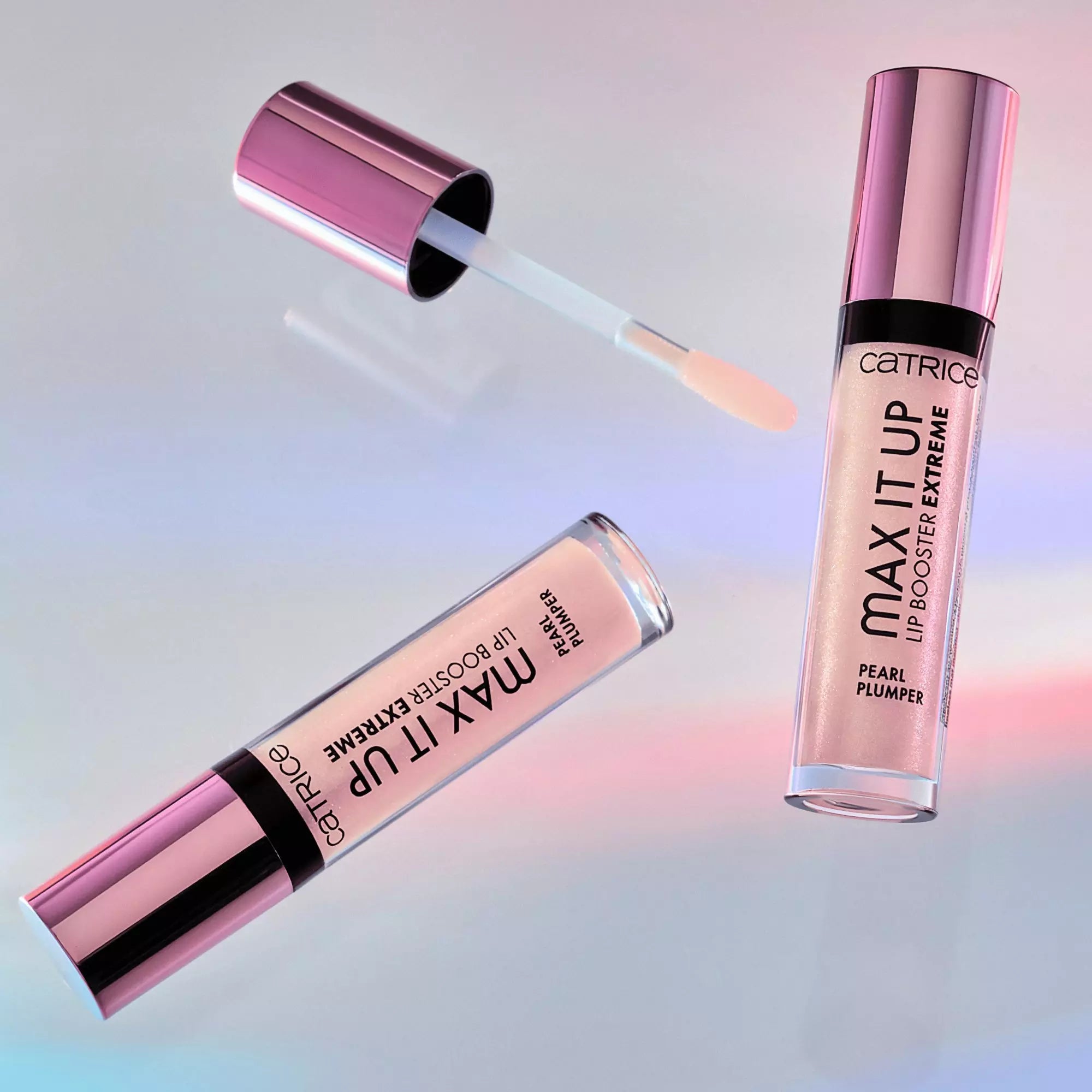 Catrice Max It Up Lip Booster 070 flat lay – open gloss tube with pink shimmer on holographic surface