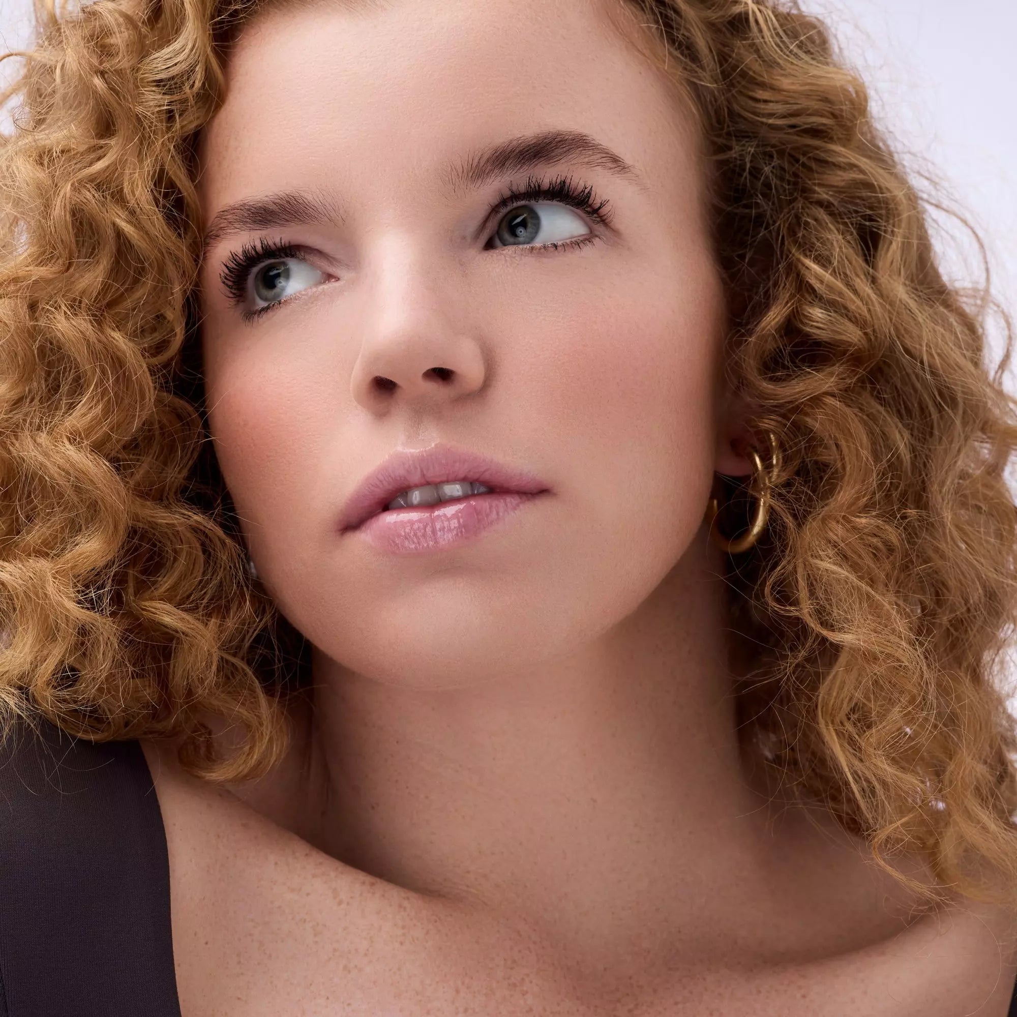 Close-up of model with glossy berry lips