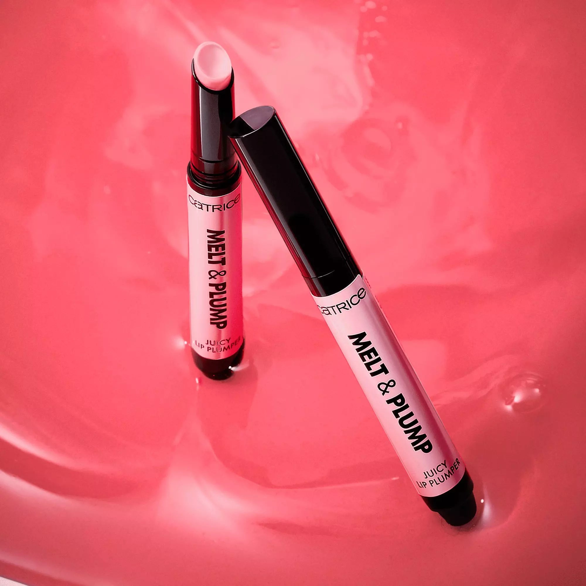Flatlay of Catrice More Amore lip plumpers on melted pink background – product aesthetic shot