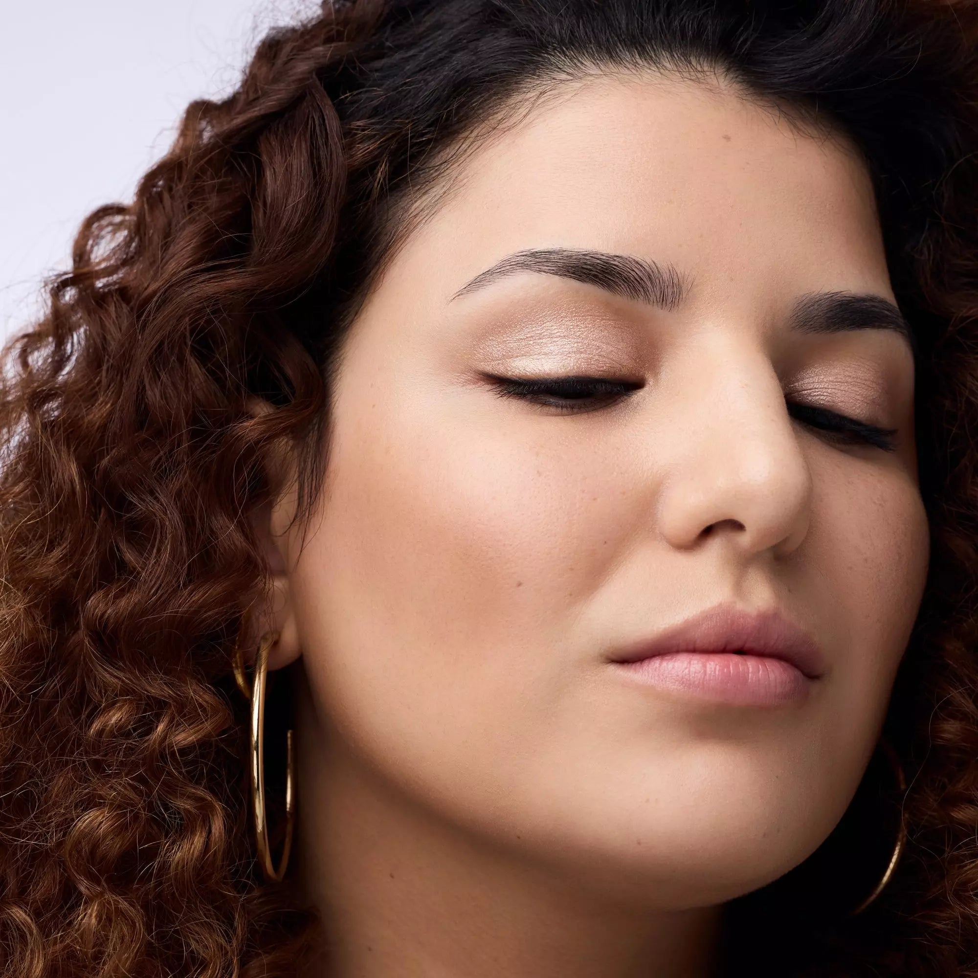 Model wearing Catrice Metallic Spark Eyeshadow 010 for luminous daytime glam”