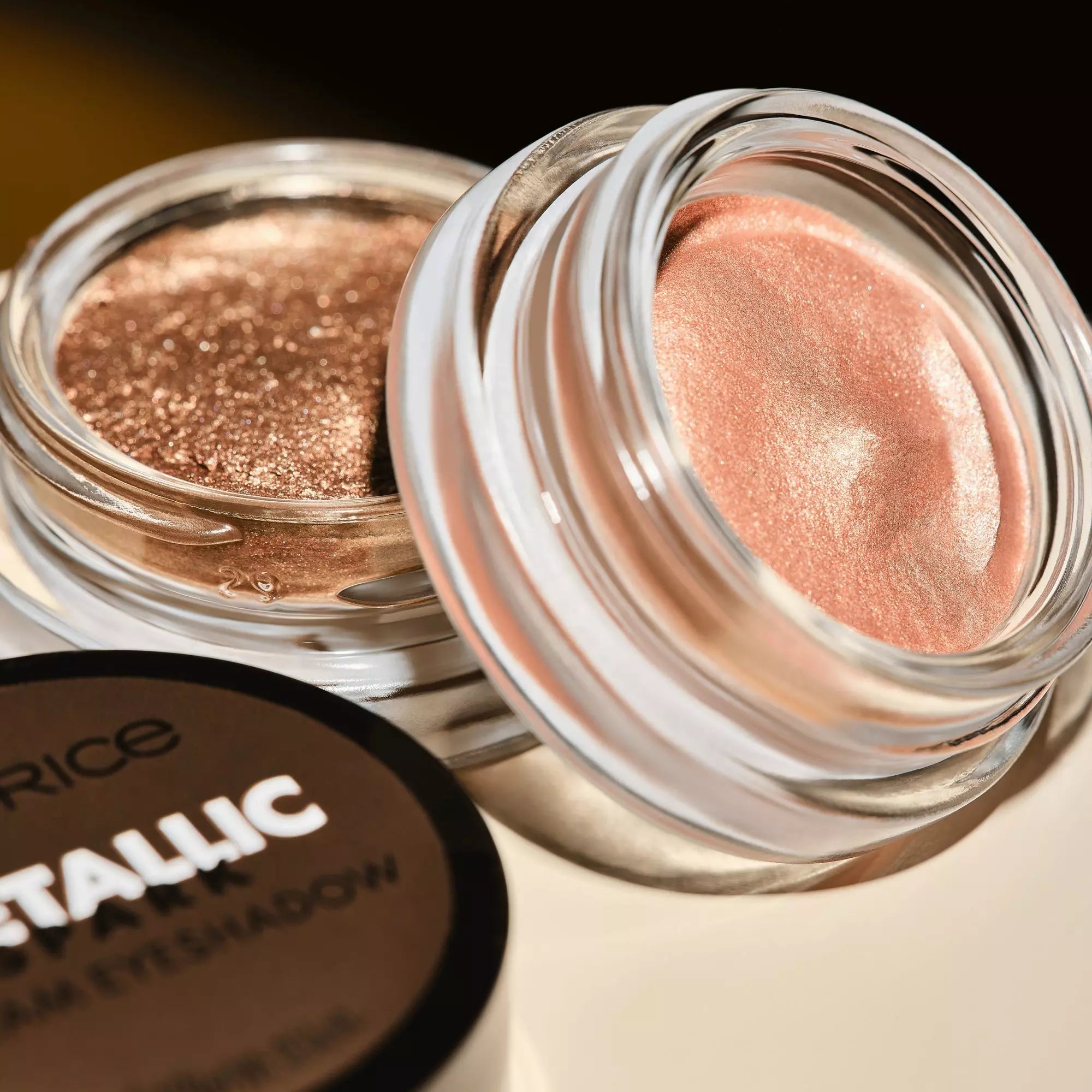 Sparkling champagne eyeshadow shimmer in open Catrice jar with glossy light