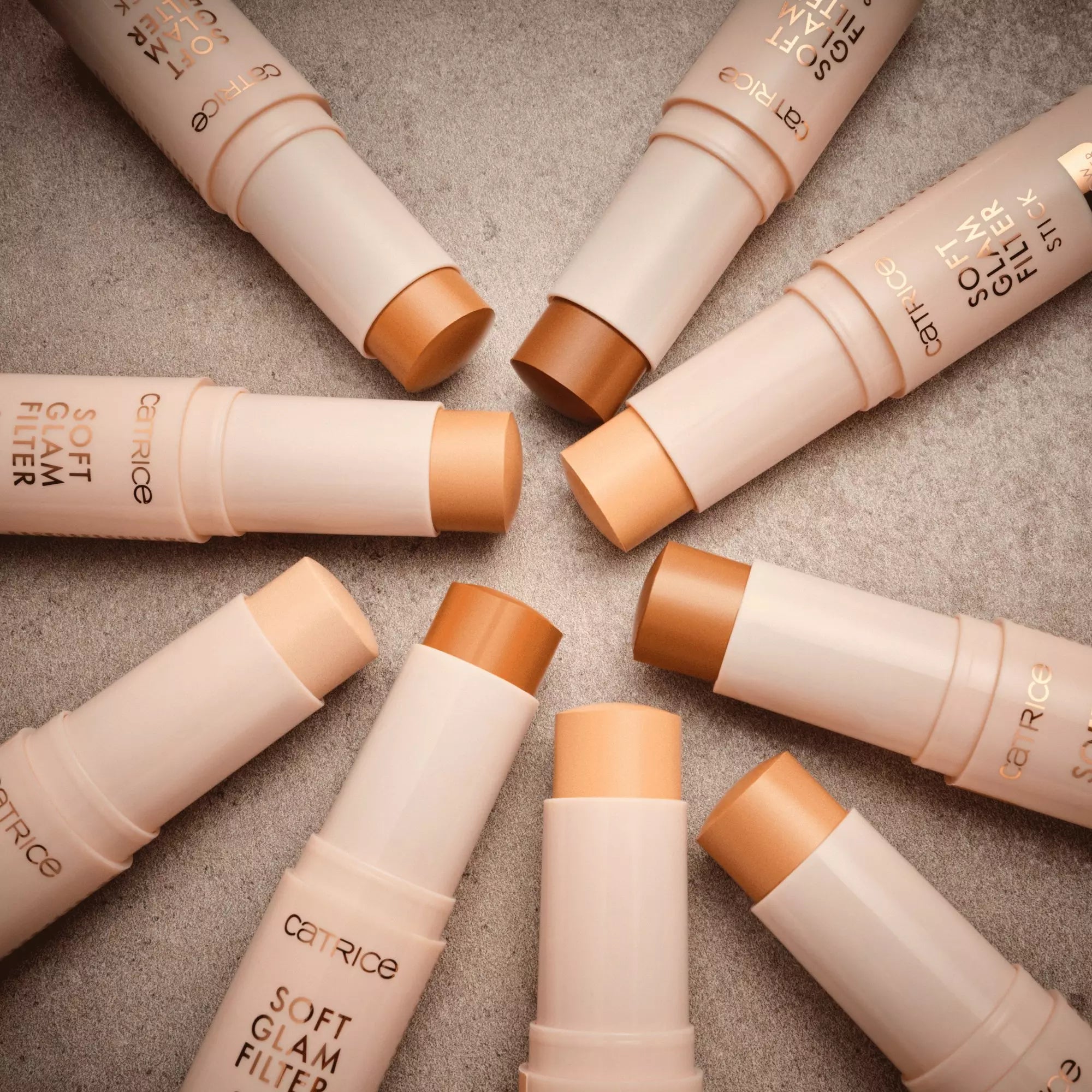 Flatlay of Catrice Soft Glam Filter Stick shades on neutral background