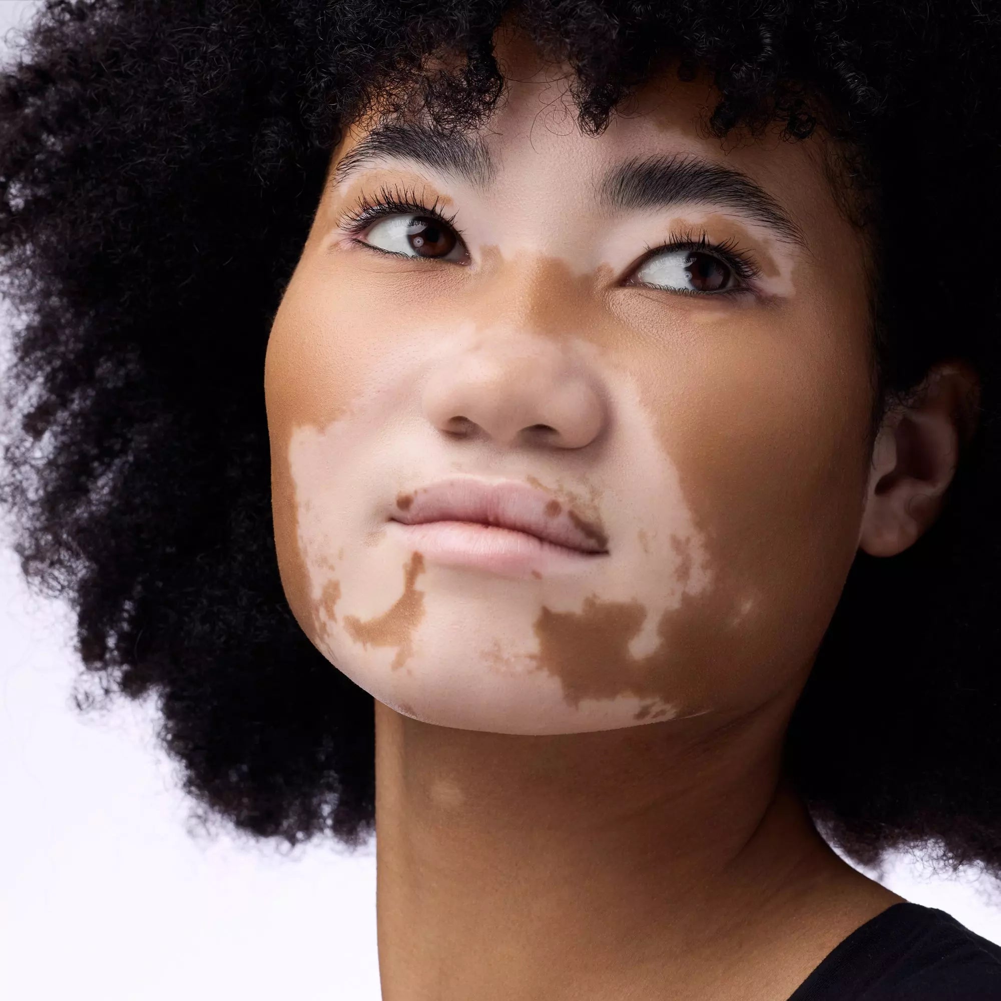Model wearing Catrice Under Eye Brightener powder under eyes