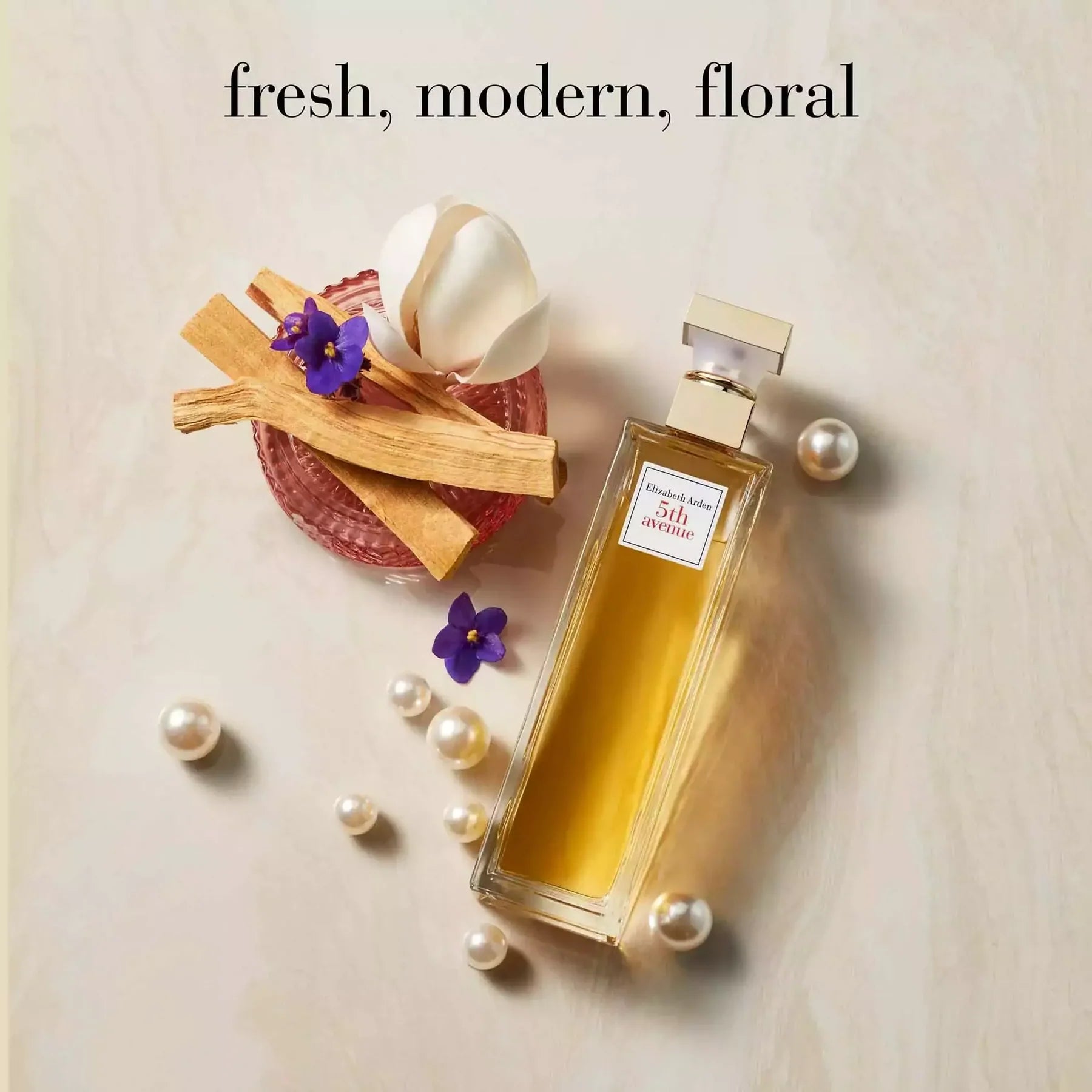 5th Avenue EDP 75ml product shot with floral accents — floral-woody perfume for women, gift-ready.