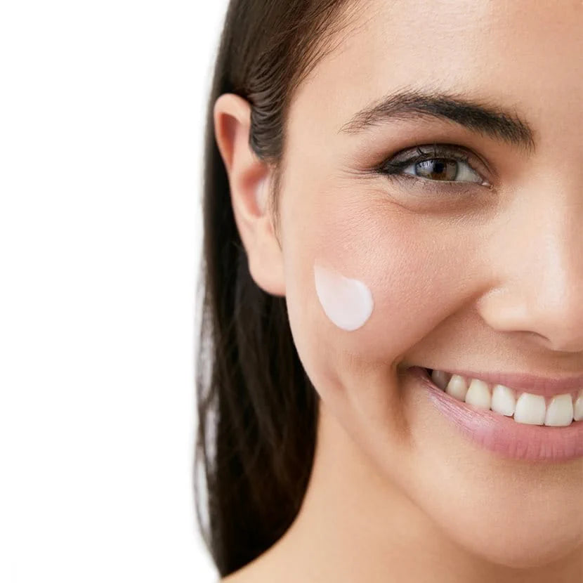 Woman applying Eucerin UreaRepair Night Cream to face for hydration