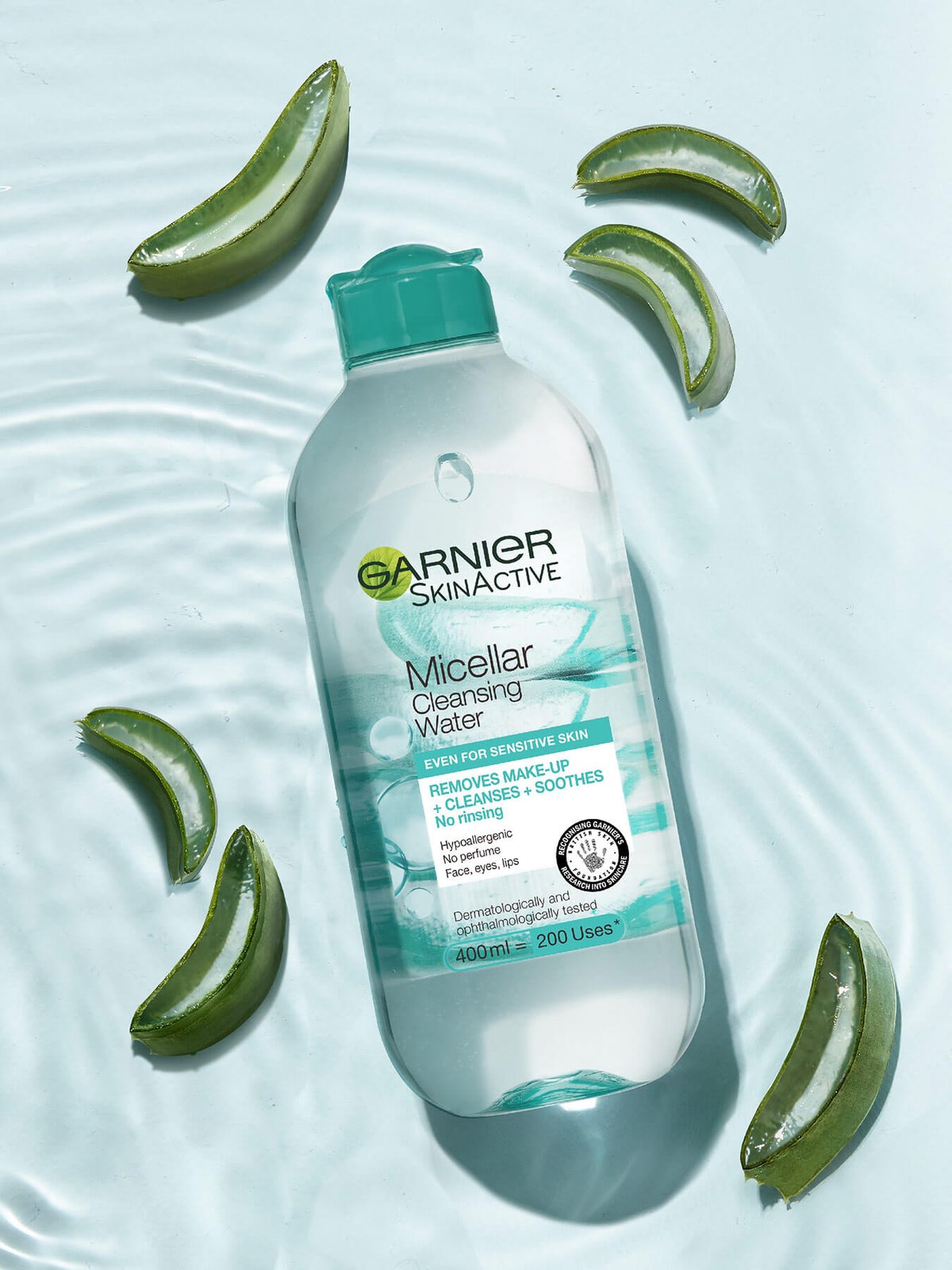 Bottle of Garnier SkinActive Micellar Cleansing Water with aloe vera leaves on a water surface