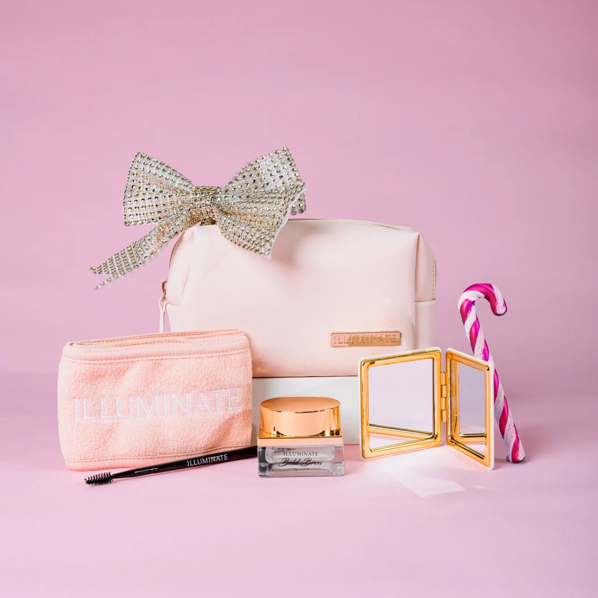 Illuminate by Shauna beauty gift collection with pink makeup bag, headband, brow products and gold compact mirror