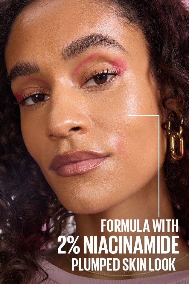 Model wearing Maybelline Grippy Primer with radiant, even finish