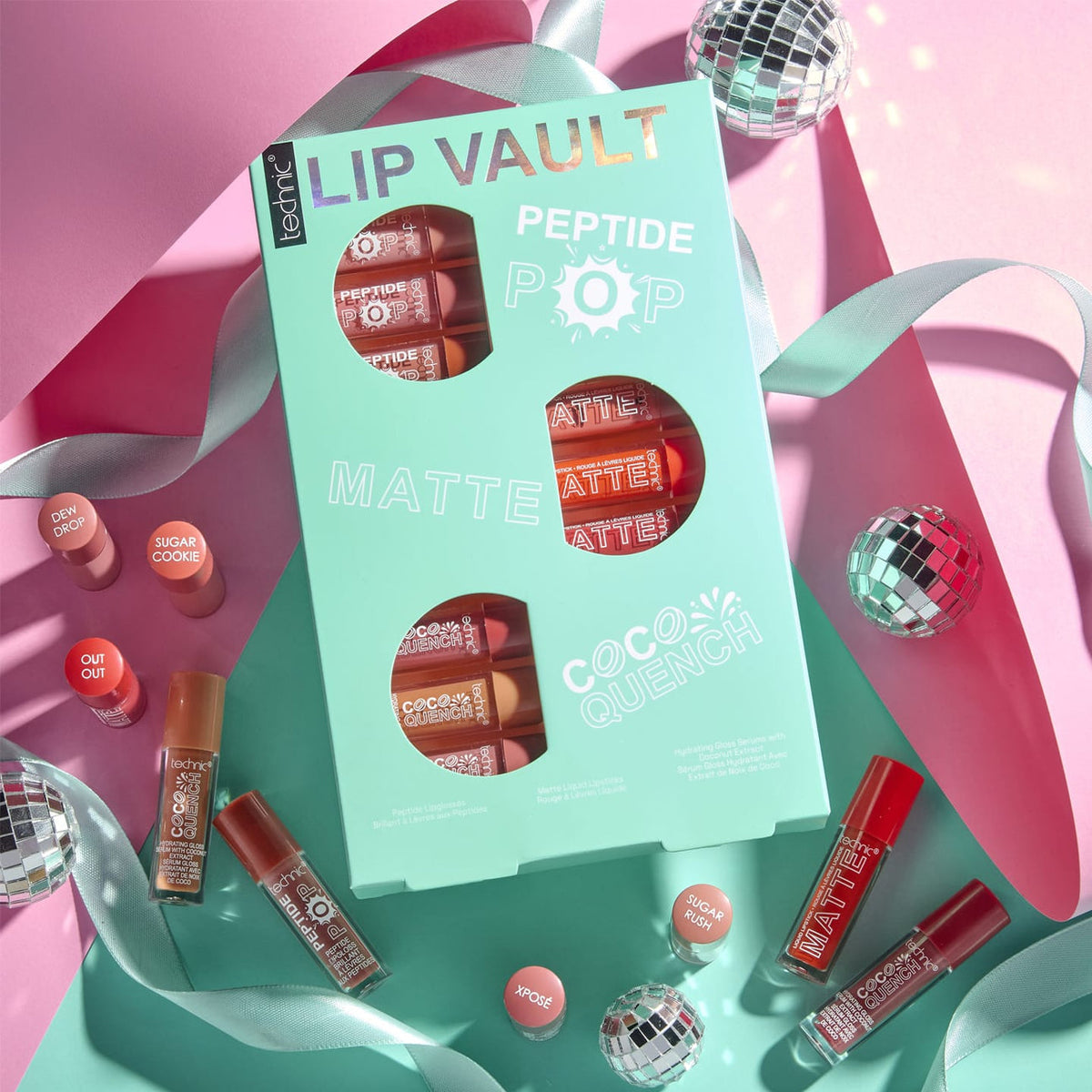 Technic Lip Vault Gift Set with mini lip glosses, matte lipsticks and Coco Quench serums displayed with pink ribbons