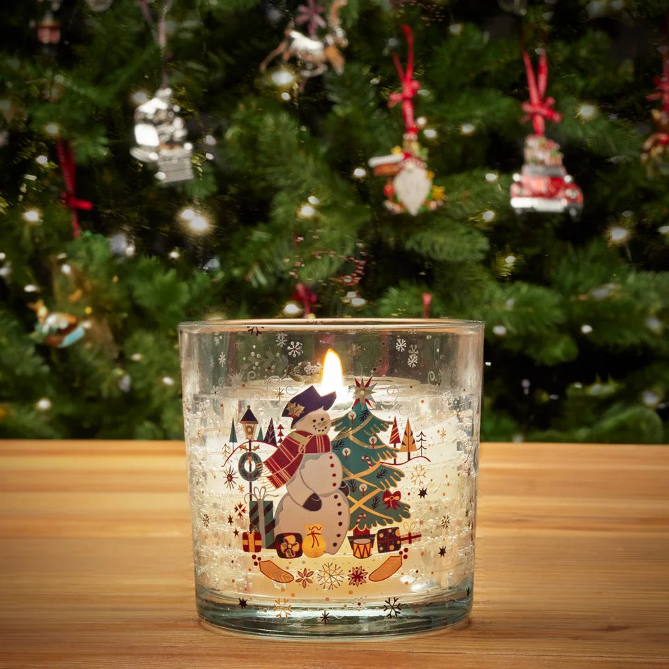 Tipperary Crystal Snowman LED Candle lit beside Christmas tree