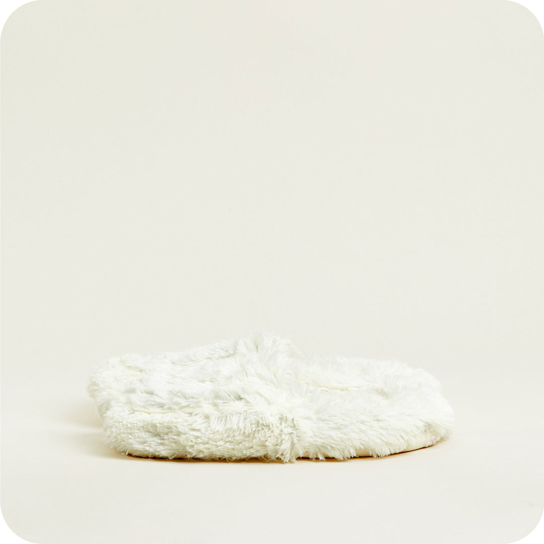 Warmies slipper sole view — low-profile sole on cream microwavable slippers for home wear.
