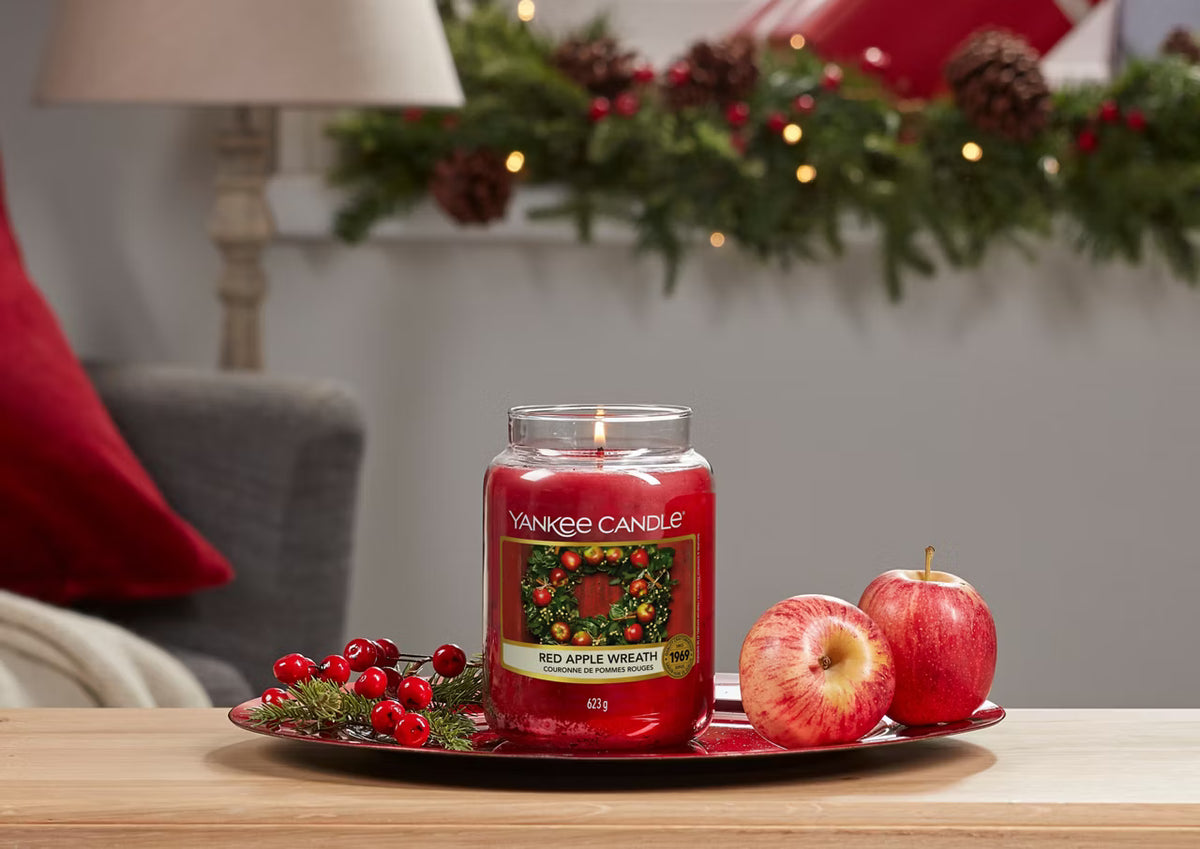 Yankee Candle Red Apple Wreath Large Jar Candle lit with apples and Christmas decorations